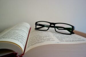 image of book with glasses representing Facts about Social Anxiety